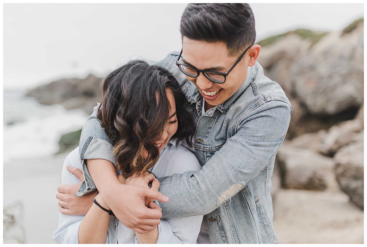 couple laughing during photo session at Harbor Cove beach
