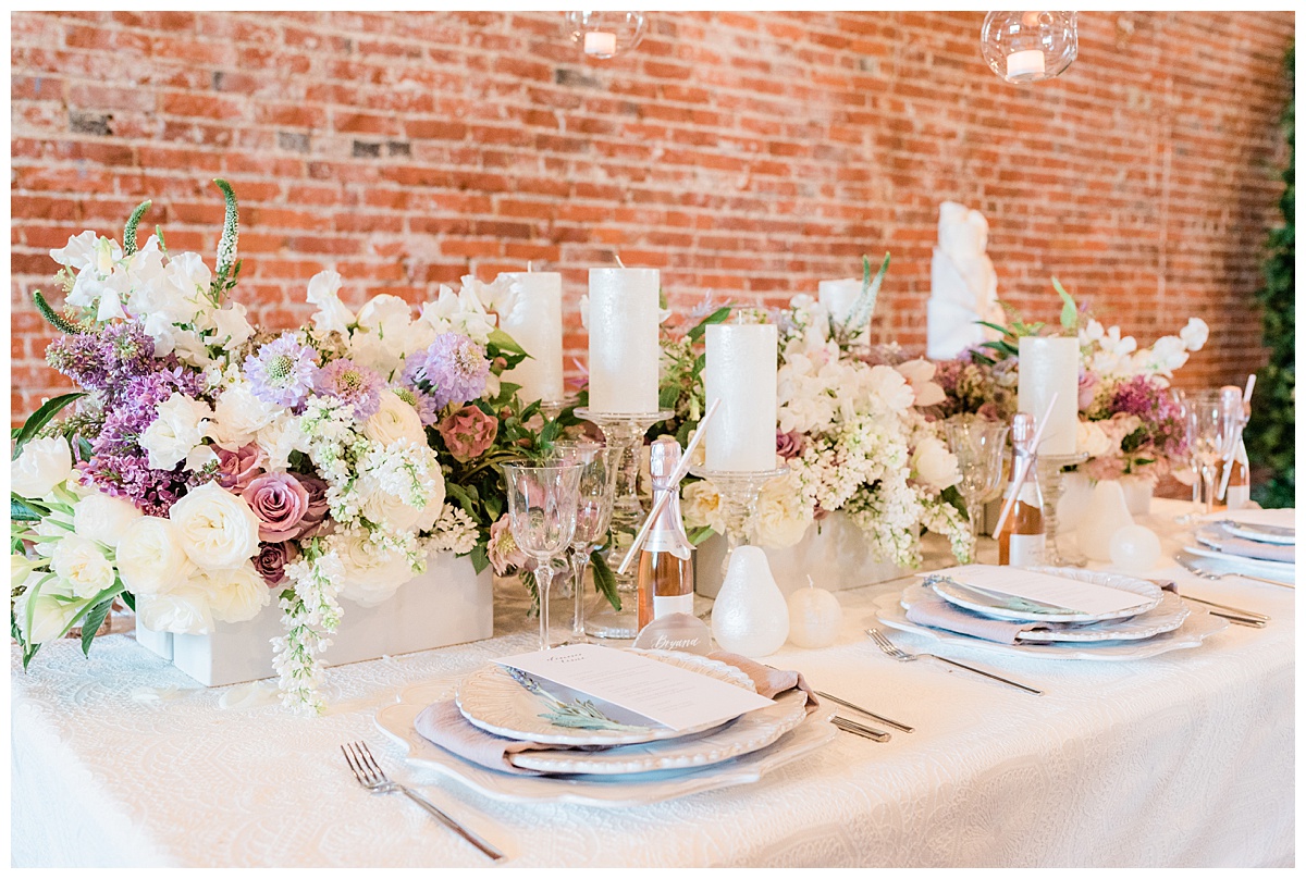 wedding tablescape with white tones and purple accents