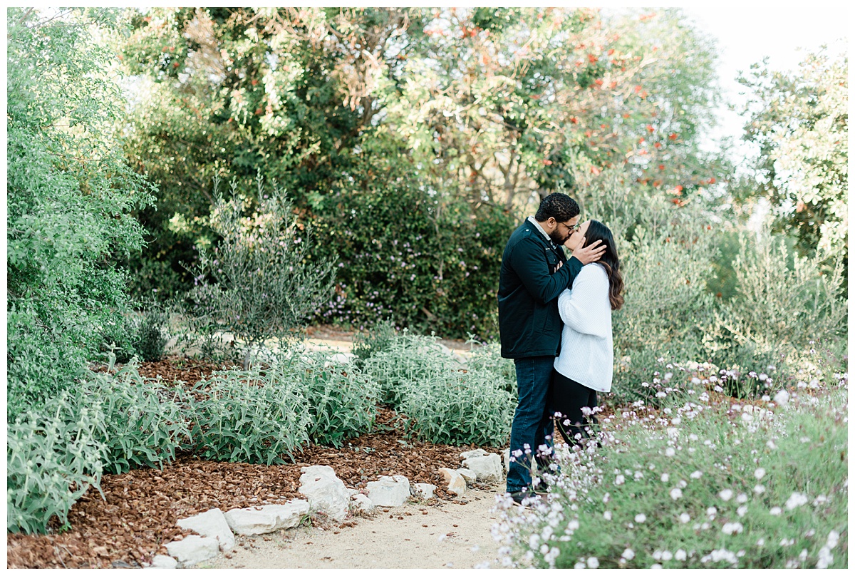 couple kissing in south coast botanic garden